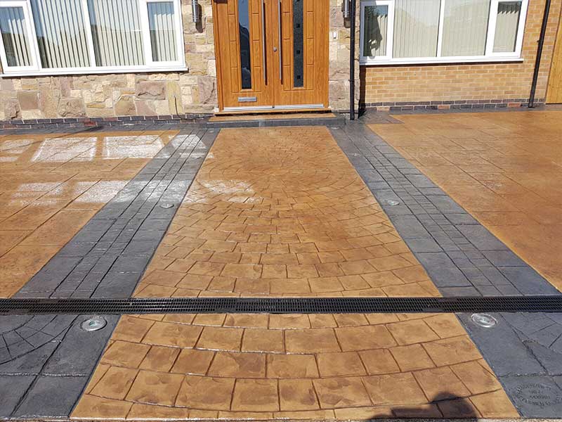 Creative Concrete patterned imprinted pathway leading to front door